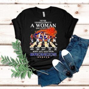 Never Underestimate A Woman Who Loves Fall And Her Denver Broncos Walking Across Signatures Shirt Never Underestimate A Woman Who Loves Fall And Her Denver Broncos Walking Across Signatures Shirt