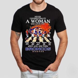 Never Underestimate A Woman Who Loves Fall And Her Denver Broncos Walking Across Signatures Shirt