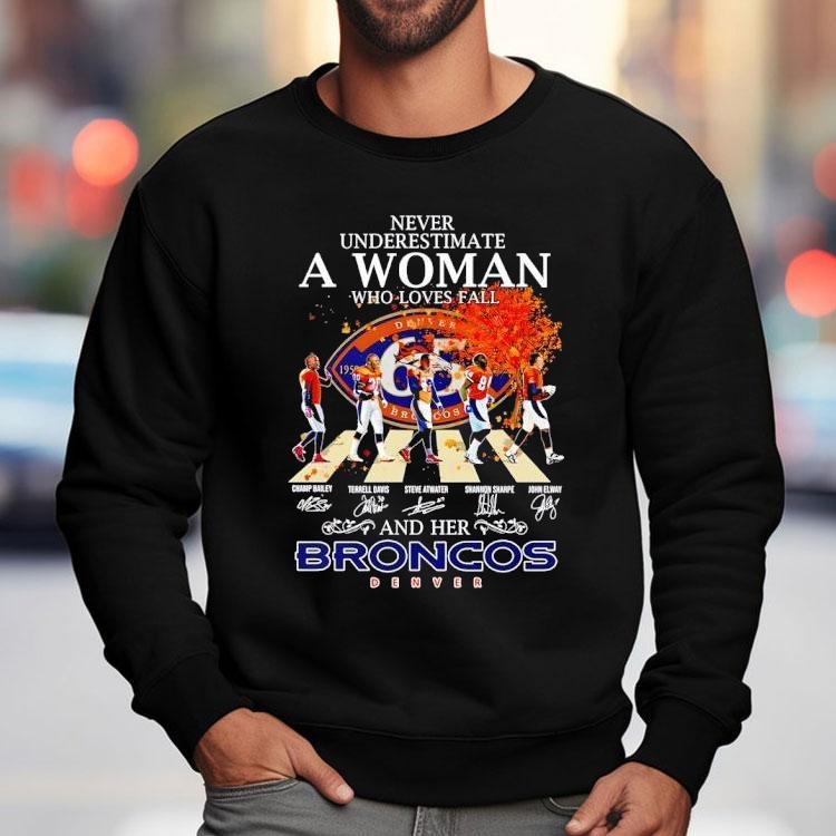 Never Underestimate A Woman Who Loves Fall And Her Denver Broncos Walking Across Signatures Shirt Never Underestimate A Woman Who Loves Fall And Her Denver Broncos Walking Across Signatures Shirt