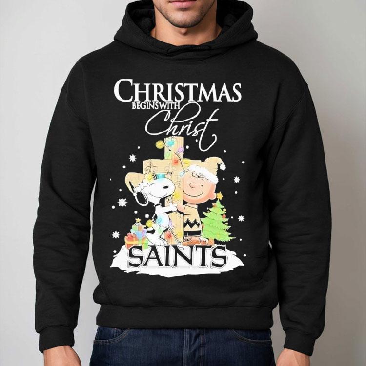 Snoopy And Charlie Brown The Peanuts X New Orleans Saints Merry Christmas Begins With Christ Shirt Snoopy And Charlie Brown The Peanuts X New Orleans Saints Merry Christmas Begins With Christ Shirt
