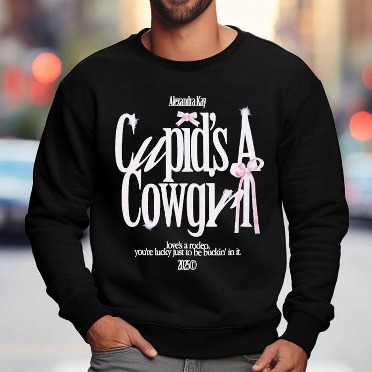 Alexandra Kay Cupid’s A Cowgirl Love’s A Rodeo You’re Lucky Just To Be Fuckin’ In It 2025 Bow Shirt Alexandra Kay Cupid’s A Cowgirl Love’s A Rodeo You’re Lucky Just To Be Fuckin’ In It 2025 Bow Shirt